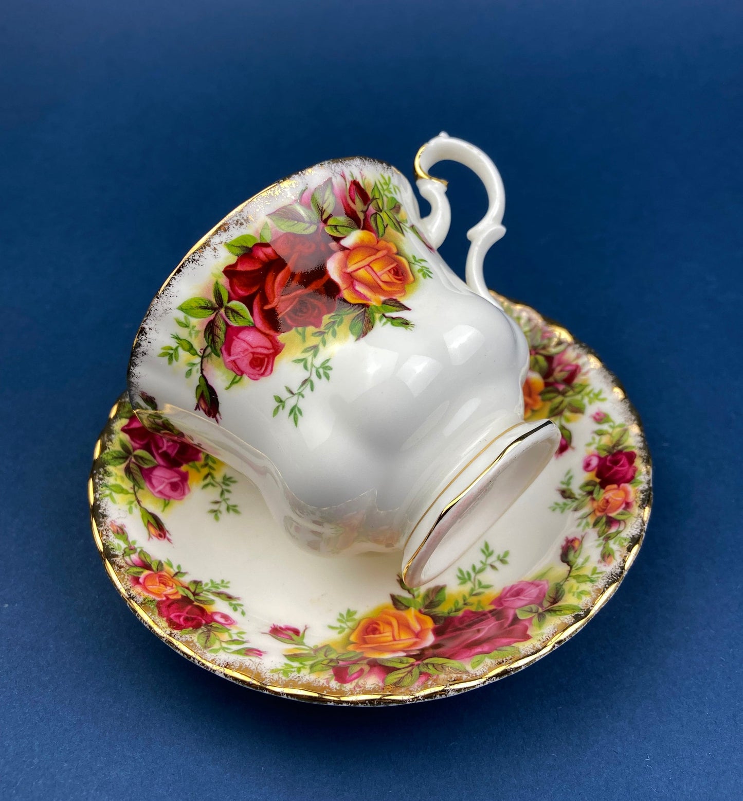 Black Cup and Saucer with Roses on White Background Inside the Cup. Royal Albert Old Country Rose Tea Set. Hand Painted Pink & Red Roses.