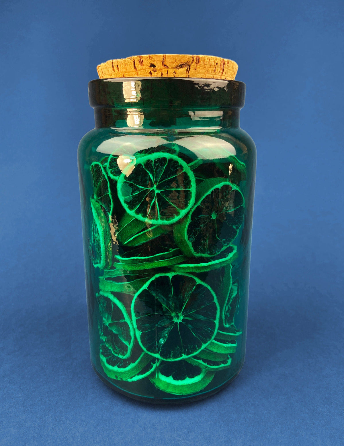 Green Glass Storage Jar with Dried  Orange Slices. Large, Deep Green Glass Canister with Cork Lid. Countertop Container.