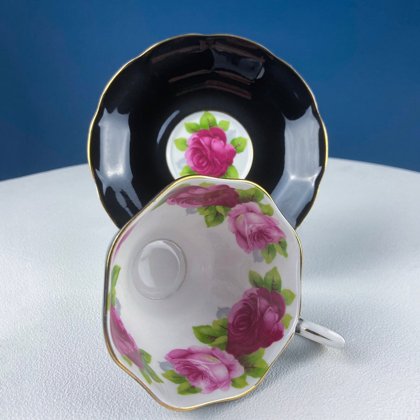 Black Cup and Saucer with Roses on White Background Inside the Cup. Royal Albert Old Country Rose Tea Set. Hand Painted Pink & Red Roses.