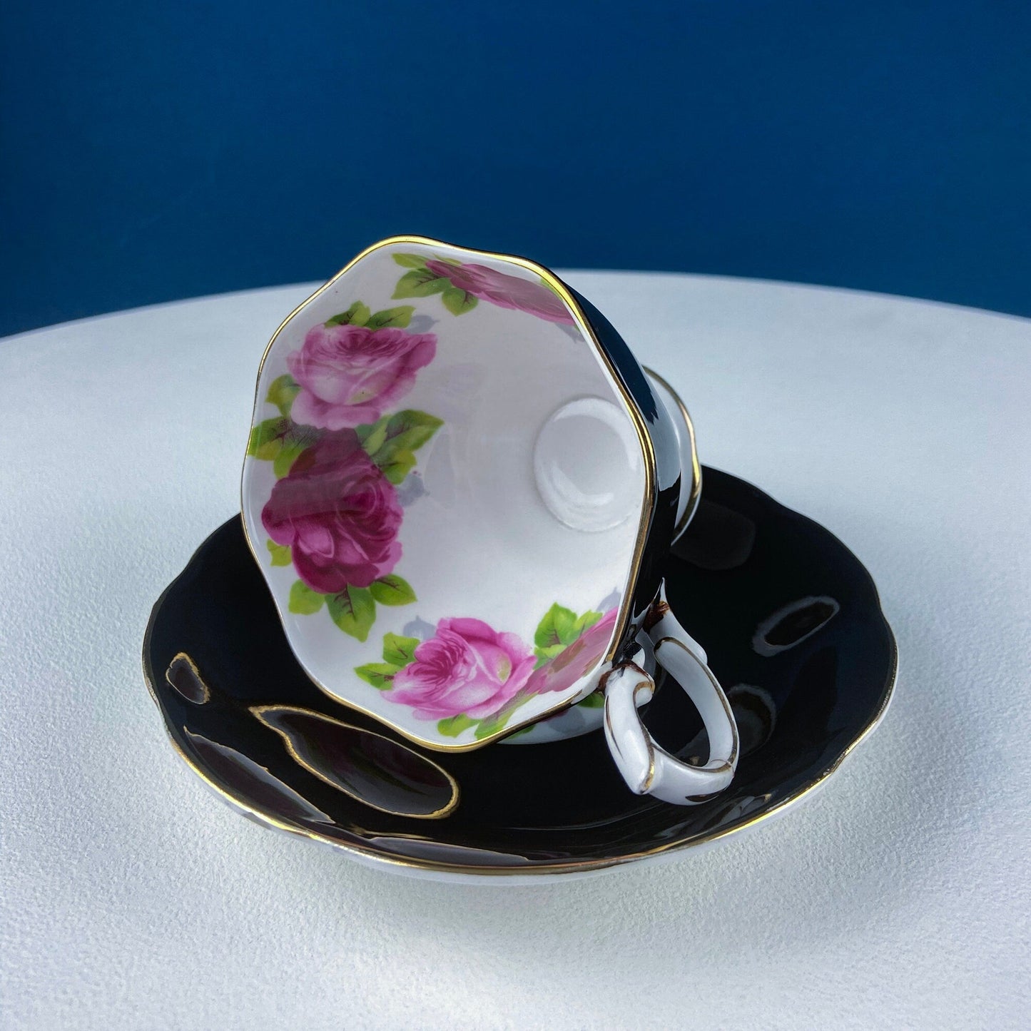 Black Cup and Saucer with Roses on White Background Inside the Cup. Royal Albert Old Country Rose Tea Set. Hand Painted Pink & Red Roses.