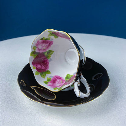 Black Cup and Saucer with Roses on White Background Inside the Cup. Royal Albert Old Country Rose Tea Set. Hand Painted Pink & Red Roses.